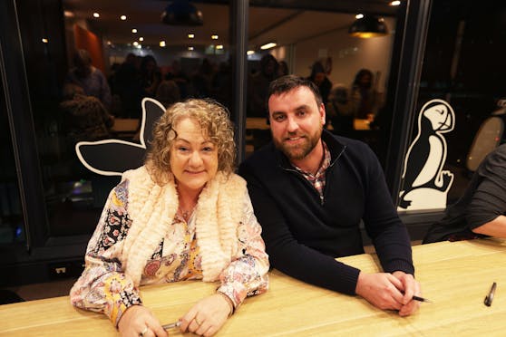 Authors Darcy Tindale (left) and Benjamin Stevenson (right) pose for a photo at the signing table.