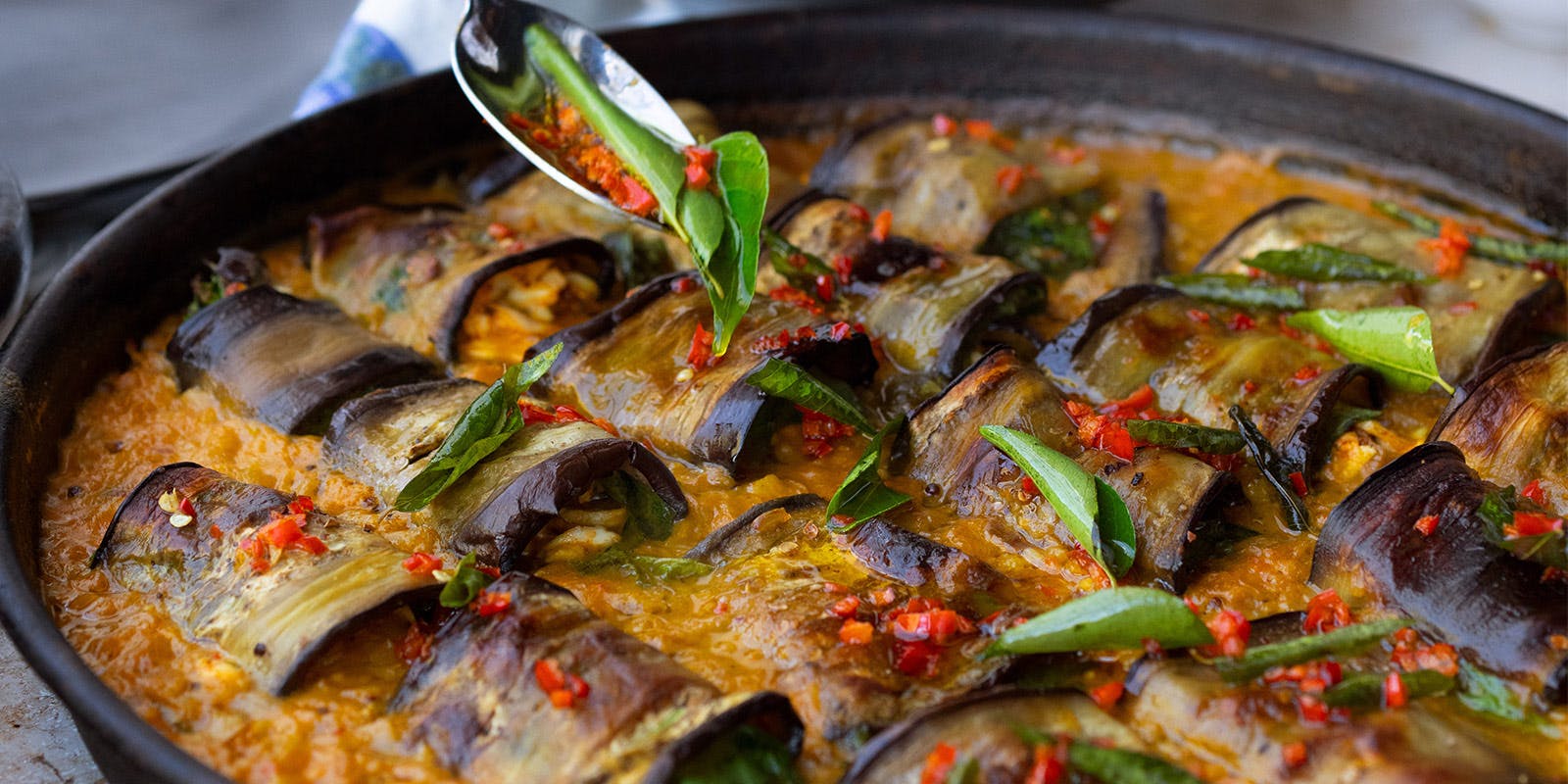 Stuffed aubergine in curry and coconut dal