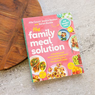 The family meal solution cookbook on a marble table. 