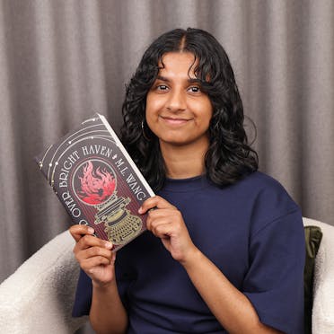 Talia holding Blood Over Bright Haven.