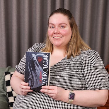 Tanaya holding Silvercloak by L.K. Steven.