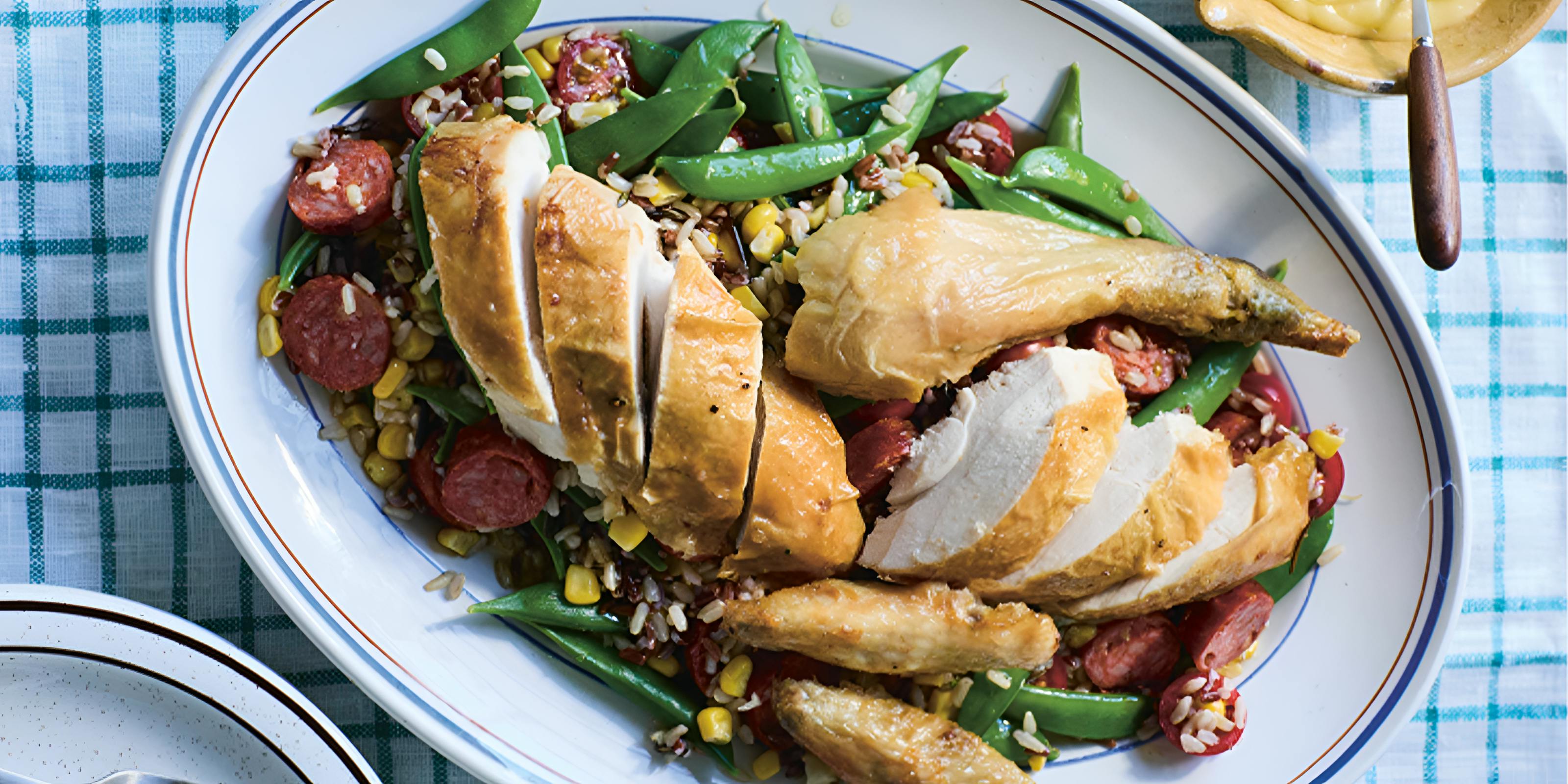 Red Camargue and wild rice, with roast chicken, chorizo, tomatoes, sweetcorn, sugar snap peas and aioli