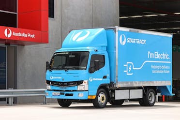 Photo of a blue StarTrack truck parked outside of Australia Post.
